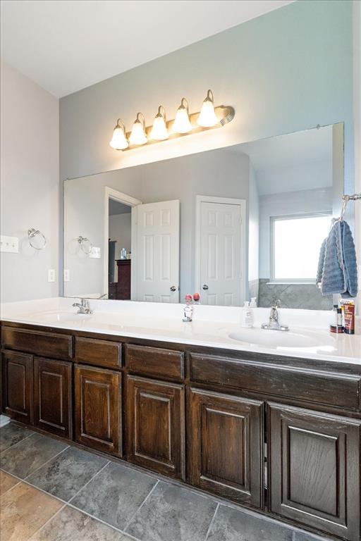 5366 Tree Grace Lane Kaufman, TX 75142 - Photo 18 of 33 a bathroom with a double vanity sink and a mirror