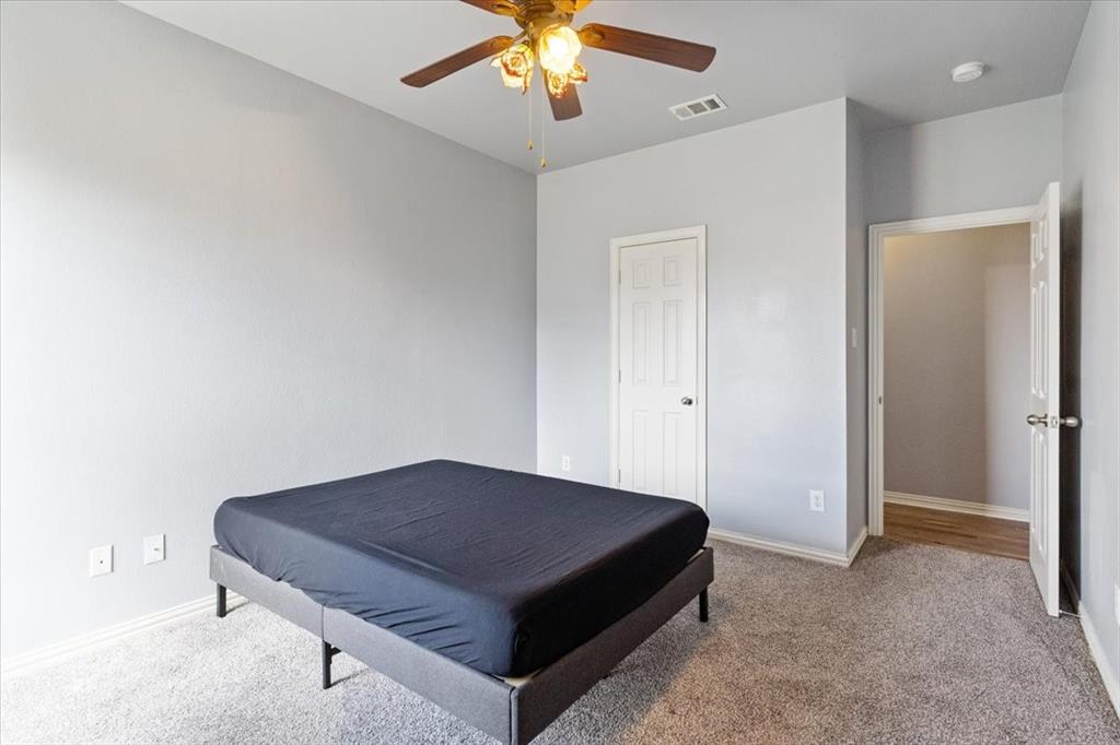 5366 Tree Grace Lane Kaufman, TX 75142 - Photo 22 of 33 a bedroom with a bed and a chandelier