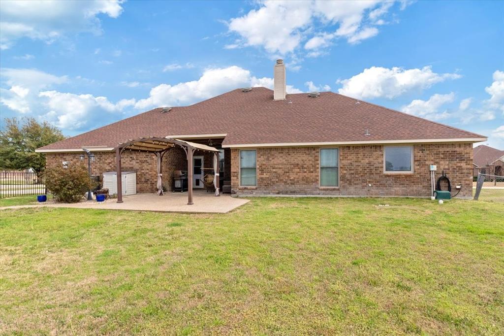 5366 Tree Grace Lane Kaufman, TX 75142 - Photo 27 of 33 a front view of a house with a garden and patio