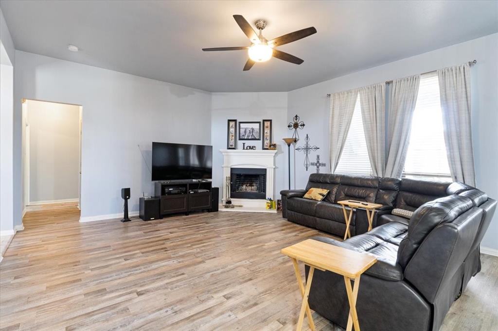 5366 Tree Grace Lane Kaufman, TX 75142 - Photo 6 of 33 a living room with furniture a flat screen tv and a fireplace