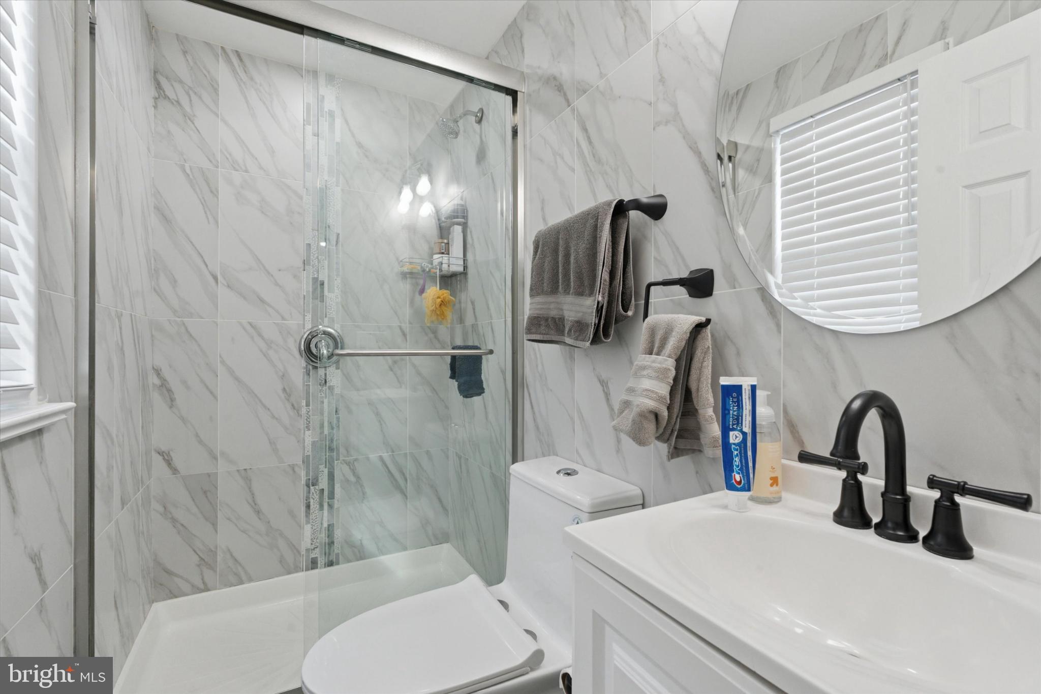 9938 Alicia Street Philadelphia, PA 19115 - Photo 10 of 15 a bathroom with a sink a toilet and shower