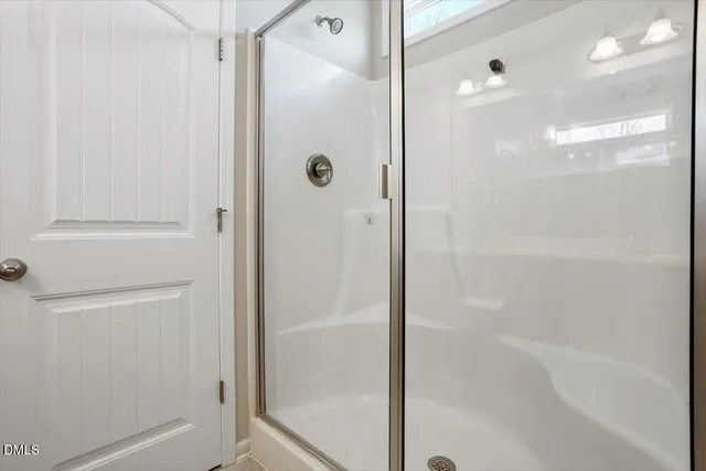 a bathroom with a glass shower door