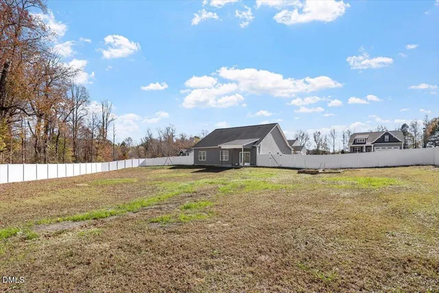 a house view with swimming pool and mountains in the background