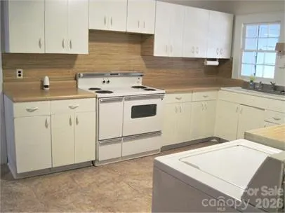 a kitchen that has a sink and a stove