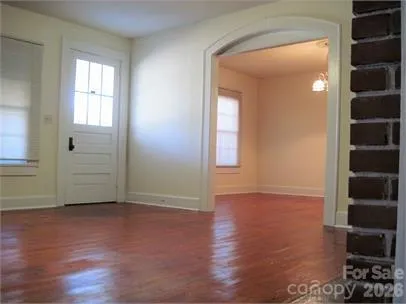 an empty room with closet and windows