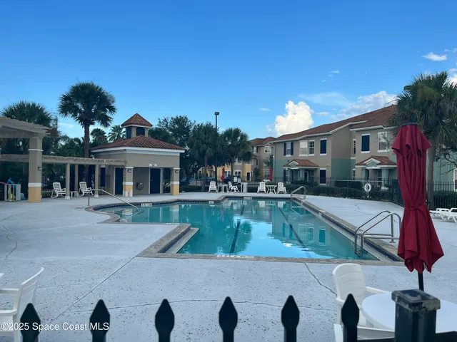 a view of a house with swimming pool and sitting area