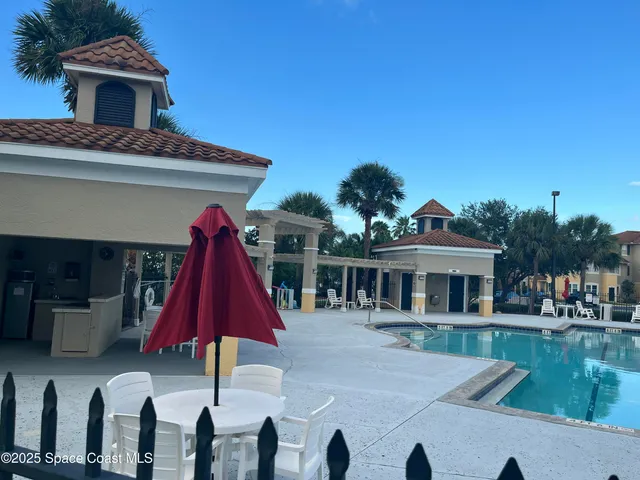 a view of house with swimming pool and porch