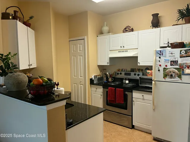 a kitchen with sink a stove and cabinets