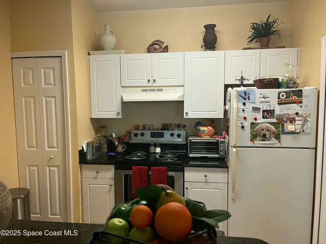 a kitchen with stainless steel appliances and cabinets