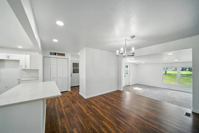 a view of a kitchen with wooden floor and a kitchen