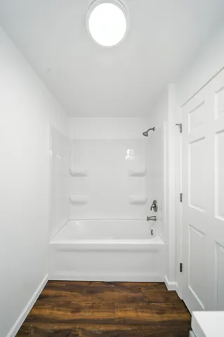 a bathroom with a bathtub and shower