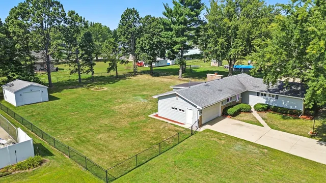 a view of a backyard with a garden and trees