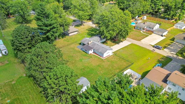 an aerial view of residential house with swimming pool and garden