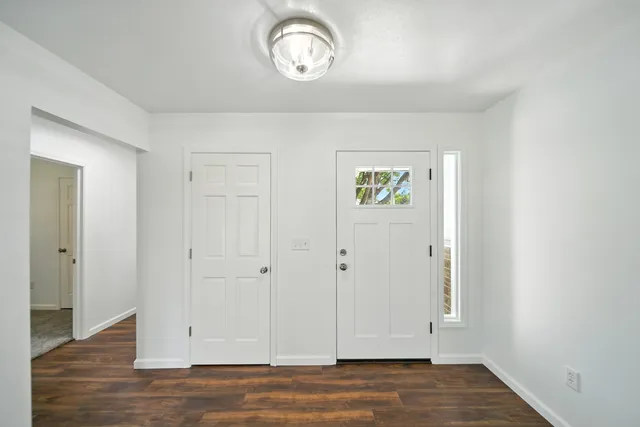 a view of an entryway with wooden floor