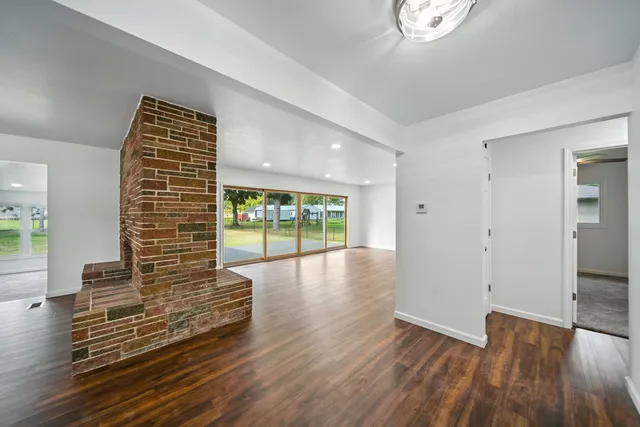 a view of a room with wooden floor
