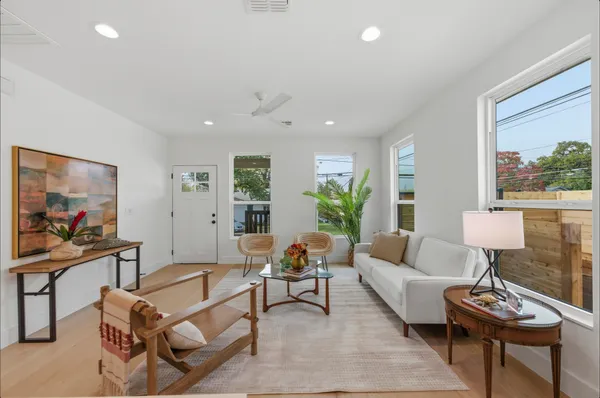 a living room with furniture and a painting on the wall