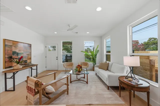 a living room with furniture and a painting on the wall