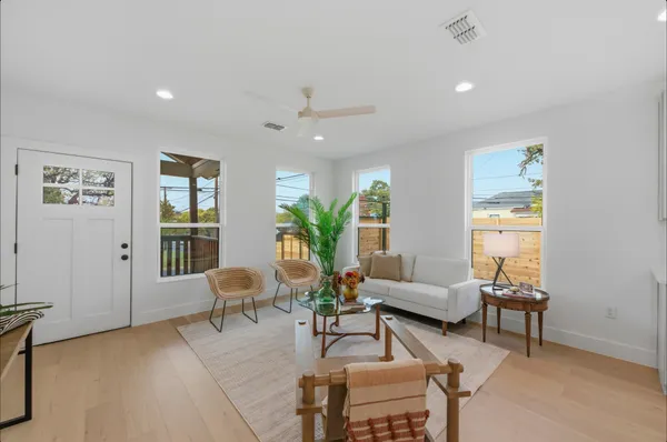 a living room with furniture and wooden floor