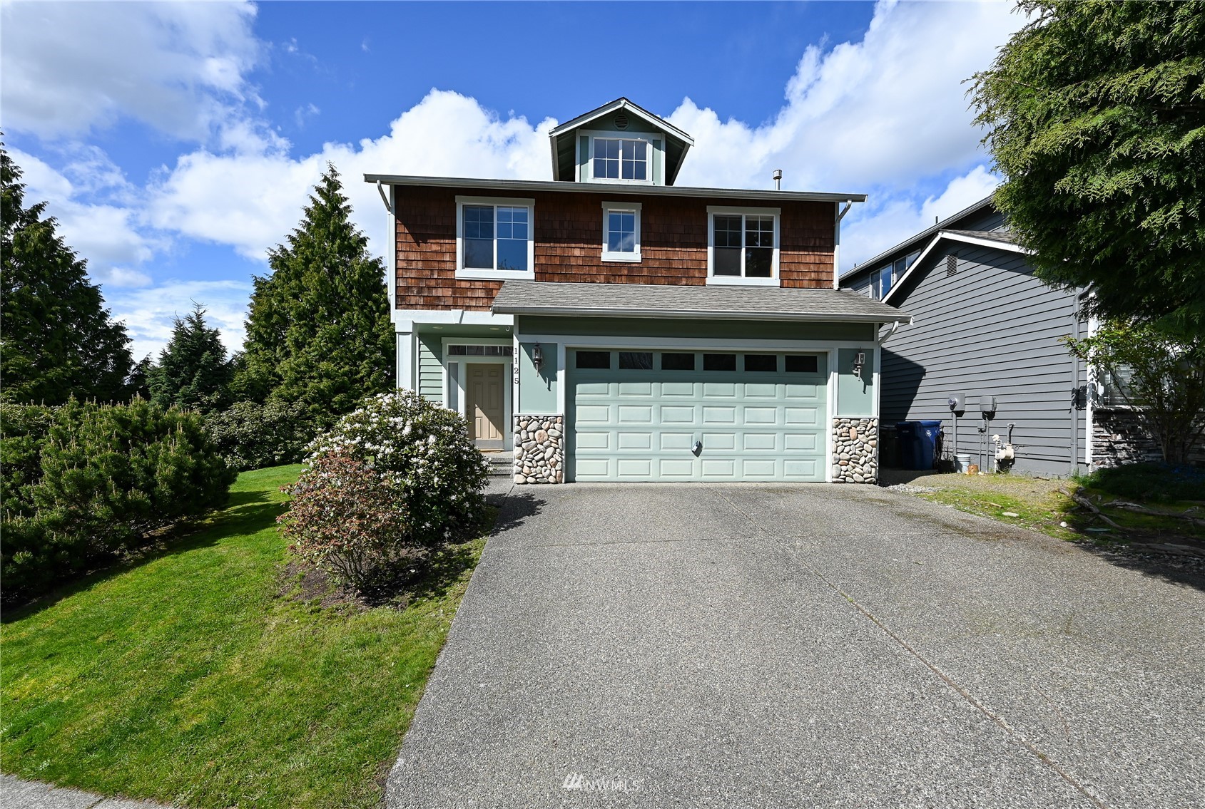 1125 185th Place Southeast Bothell, WA 98012 - Photo 1 of 23 a front view of a house with a yard and garage
