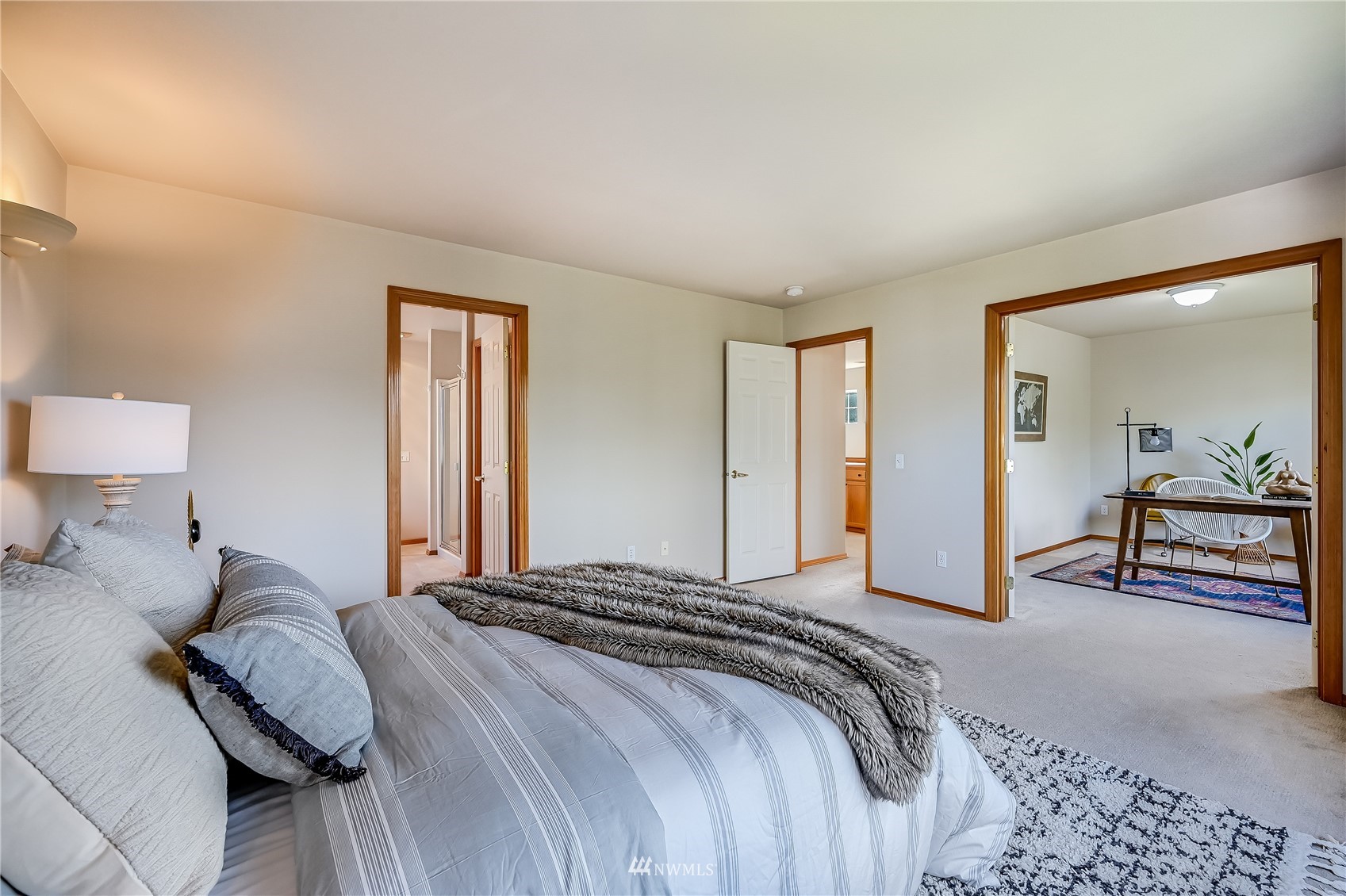 1125 185th Place Southeast Bothell, WA 98012 - Photo 14 of 23 a spacious bedroom with a bed and a lamp