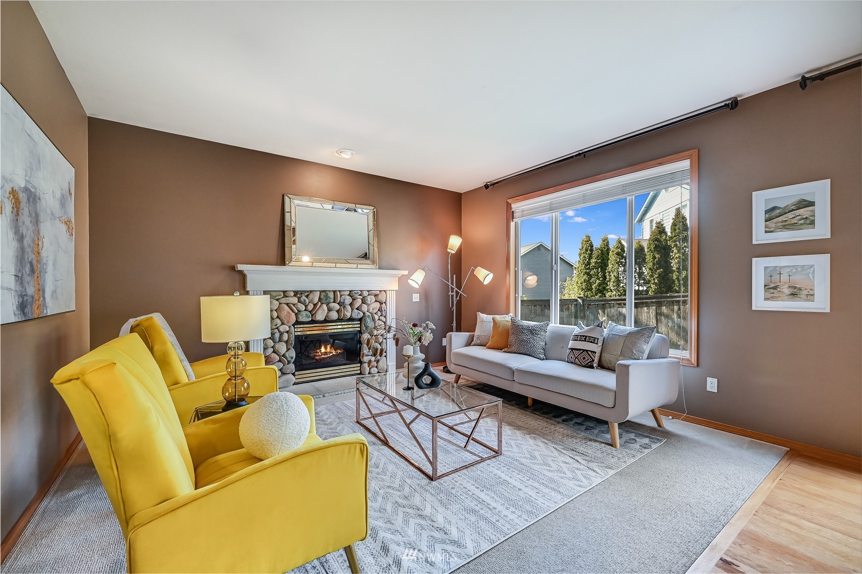 1125 185th Place Southeast Bothell, WA 98012 - Photo 6 of 23 a living room with furniture mirror and a fireplace