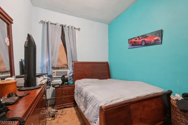 a bed sitting in a bedroom next to a window