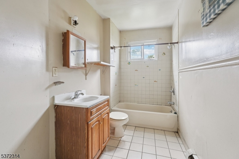405 North 8th Street Prospect Park, NJ 07508 - Photo 22 of 34 a bathroom with a sink a toilet and shower
