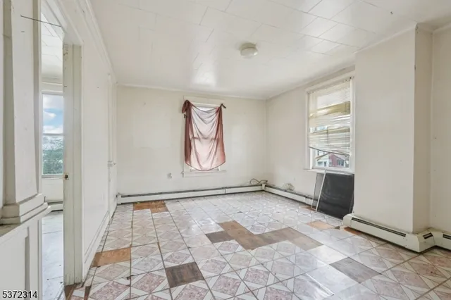 a view of an empty room and a window