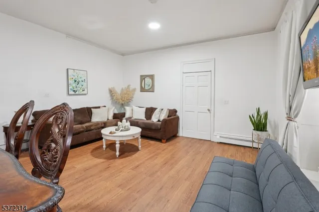 a living room with furniture and wooden floor