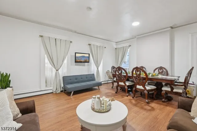 a living room with furniture a rug and a window