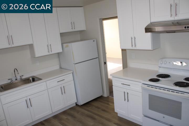 615 Lexington Avenue El Cerrito, CA 94530 - Photo 5 of 19 a kitchen with white cabinets and white appliances