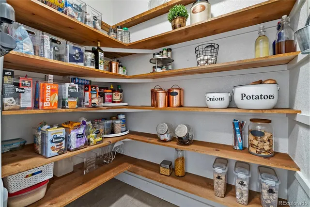 a room with lots of books and a shelf