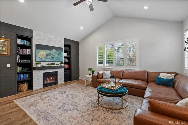 a living room with furniture a flat screen tv and a fireplace