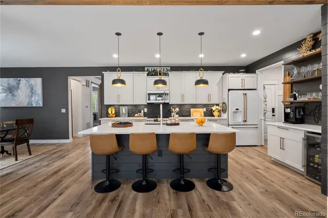 a large kitchen with a table and chairs