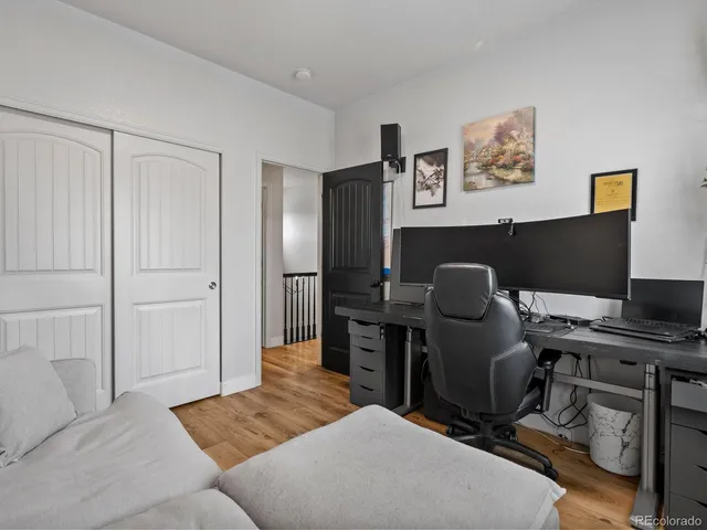 a livingroom with workspace and a couch