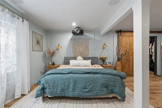 a bedroom with a bed and a mirror