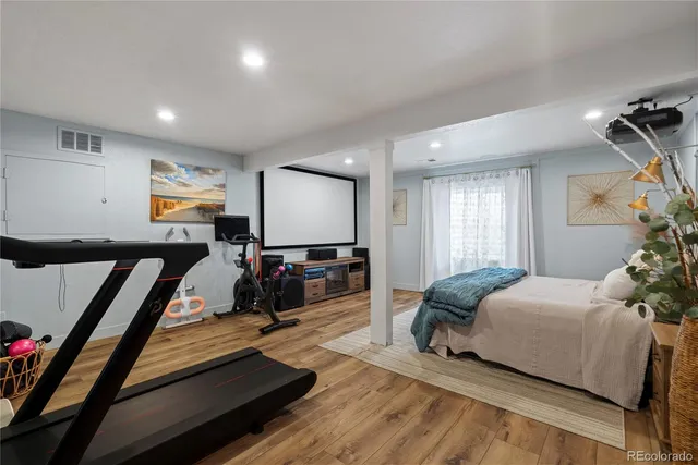 a bedroom with furniture and a flat screen tv