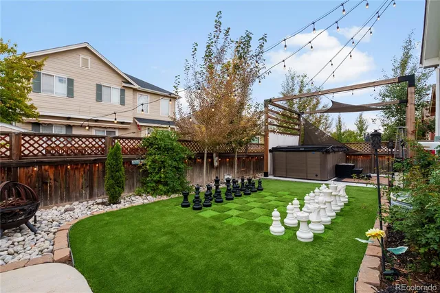 a view of a house with backyard and sitting area