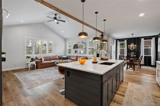 a living room with furniture a large window and a table