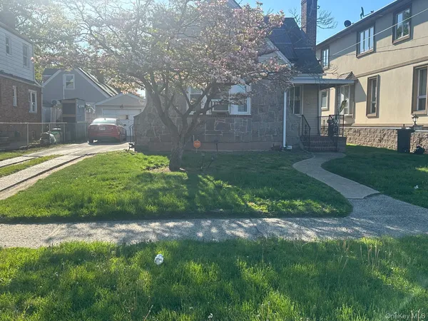 a view of a yard in front of a brick house with plants