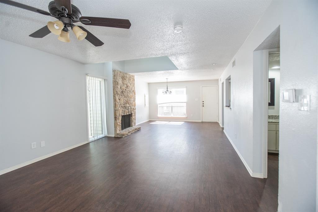2236 Irwin Street Fort Worth, TX 76110 - Photo 5 of 11 a view of an empty room with wooden floor and a window