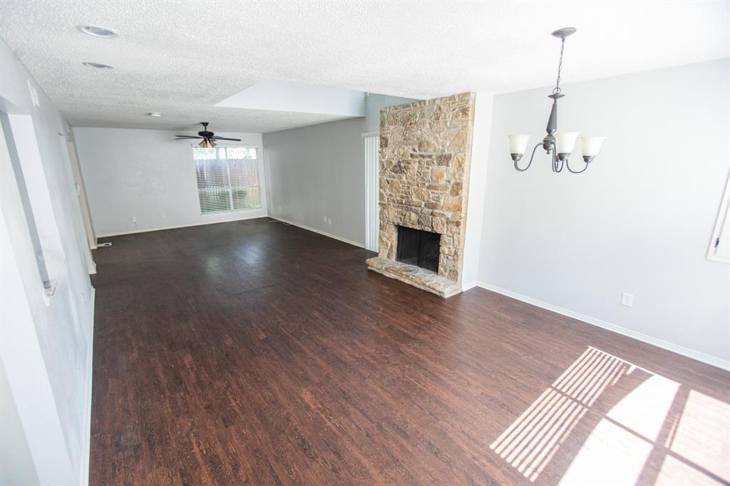 2236 Irwin Street Fort Worth, TX 76110 - Photo 6 of 11 wooden floor in an empty room with a window