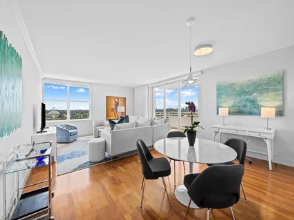 a dining room with furniture and wooden floor