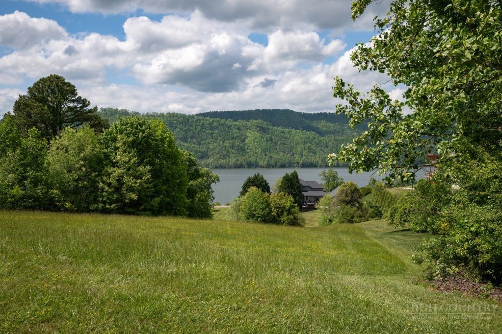 Lot 84 Harbor View Butler, TN 37640 - Photo 22 of 32 a view of a garden with a building in the background