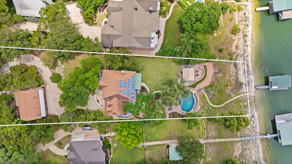 10800 Beach Road Leander, TX 78641 - Photo 36 of 39 An aerial perspective reveals a private pool, boat dock, and generous yard space, all leading to the waterfront.