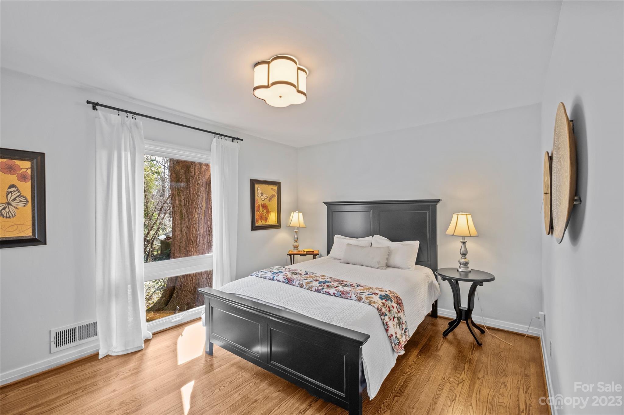 4439 Applegate Road Charlotte, NC 28209 - Photo 15 of 34 a bedroom with a bed and wooden floor