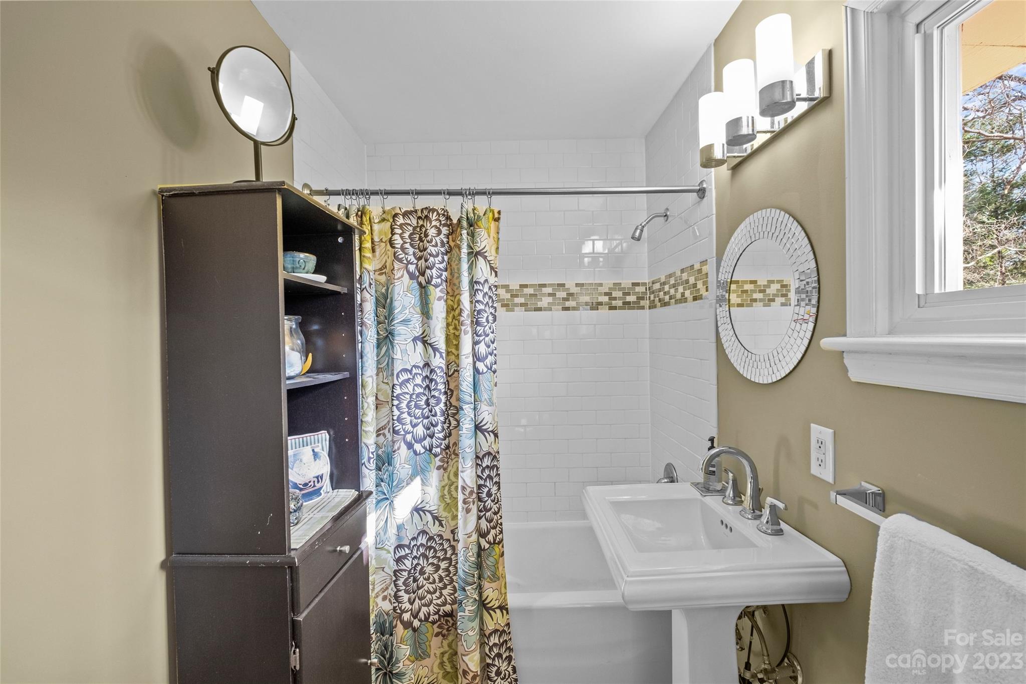 4439 Applegate Road Charlotte, NC 28209 - Photo 17 of 34 a bathroom with a sink and a mirror