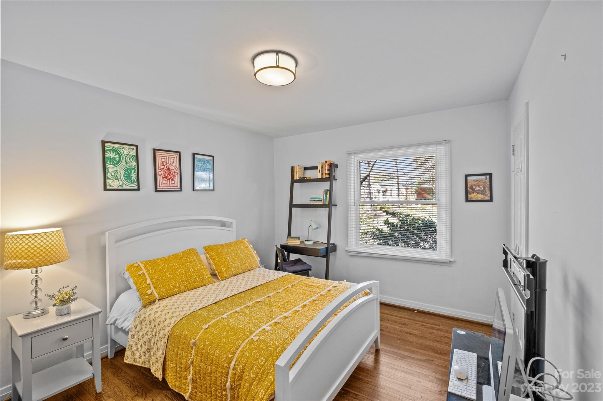4439 Applegate Road Charlotte, NC 28209 - Photo 20 of 34 a bedroom with a bed and a lamp on table