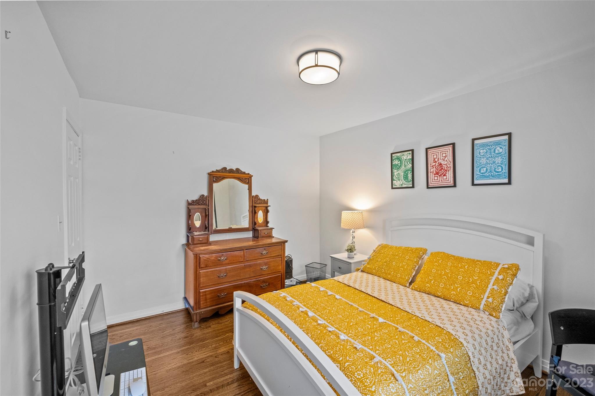 4439 Applegate Road Charlotte, NC 28209 - Photo 21 of 34 a bedroom with a bed and wooden floor