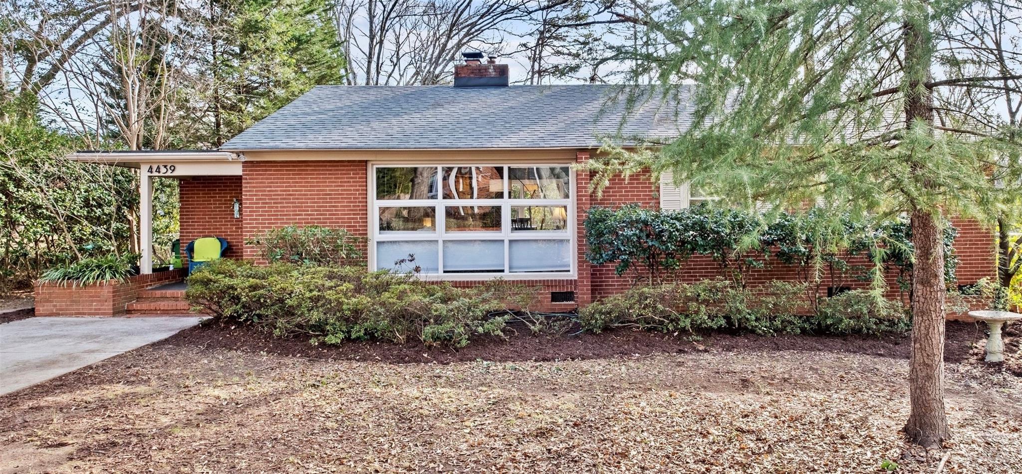 4439 Applegate Road Charlotte, NC 28209 - Photo 31 of 34 a view of a house with a yard and plants